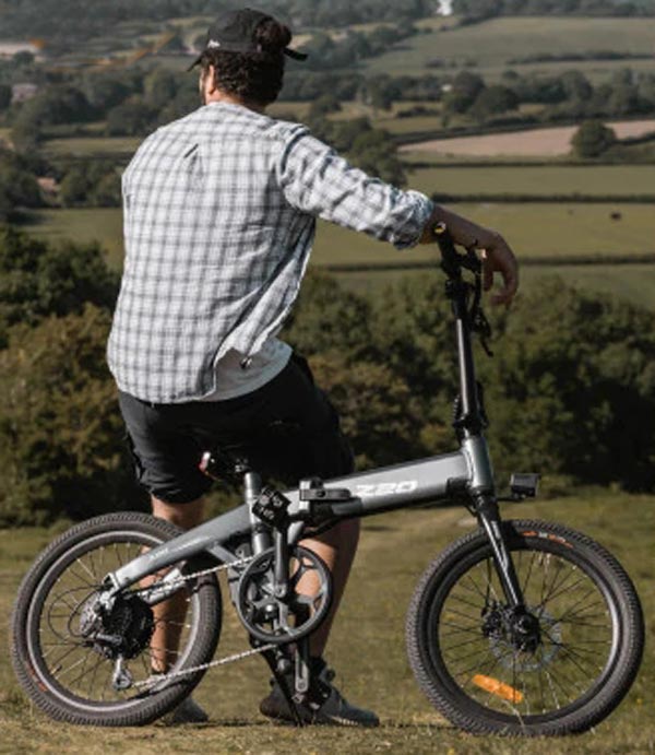 Man in countryside with the best value electric folding bike.

